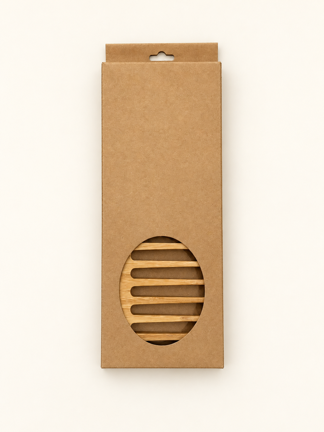 The Bamboo Comb in its plain kraft box with an oval window, on an ivory studio background.