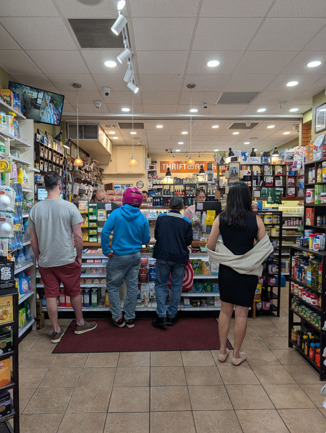 Customers being helped at the front counter inside Thriftway Pharmacy